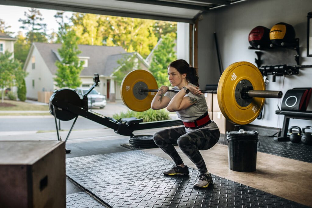 Strength Training at Home with Barbell Front Squats Person performing a barbell front squat in a home gym setting.