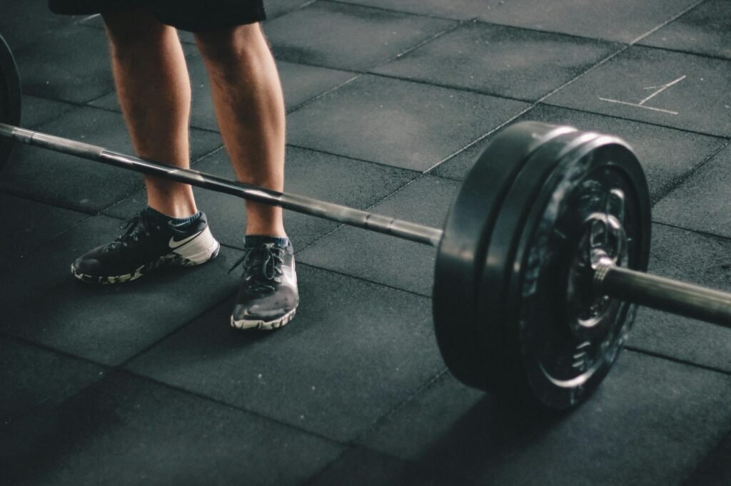 Loaded Barbell Ready for Strength Training Exercise Close-up of a loaded barbell on a gym floor for strength training exercises