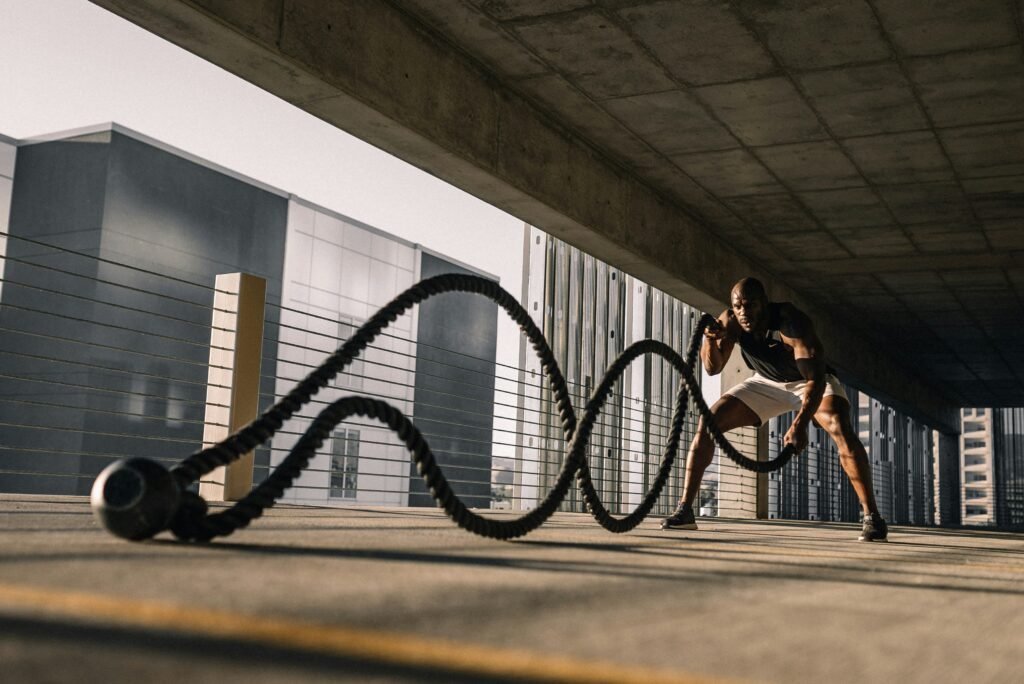 Man Training with Battle Ropes for Muscle Endurance Man using battle ropes outdoors to build muscle endurance